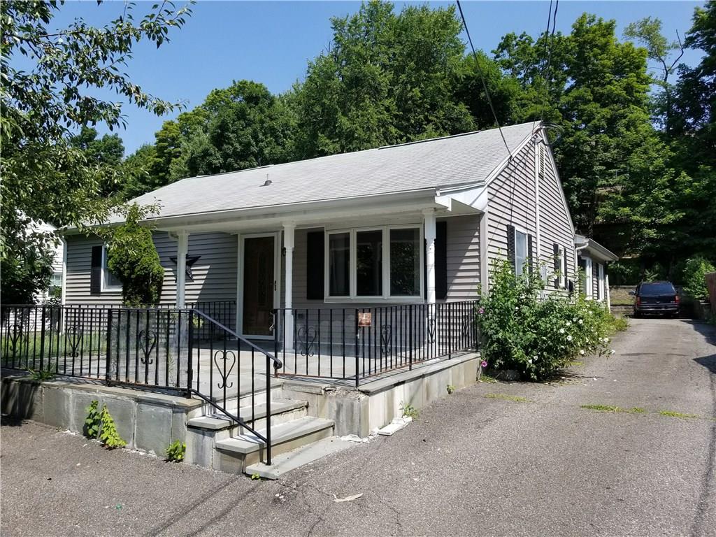 a view of a house with a small yard and plants