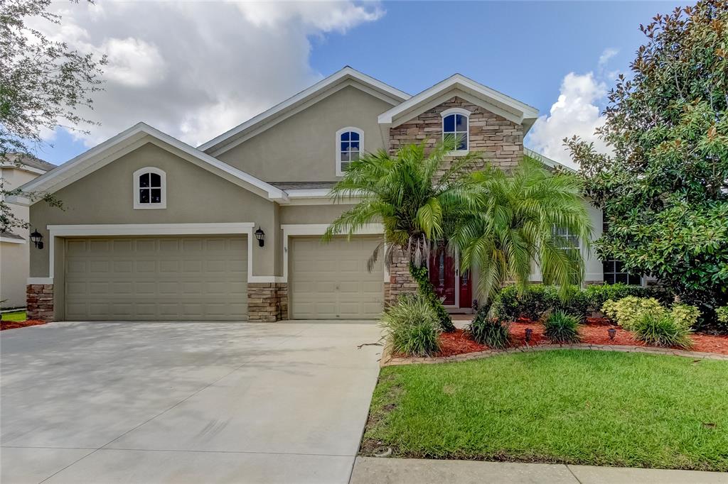 a front view of a house with a yard and garage