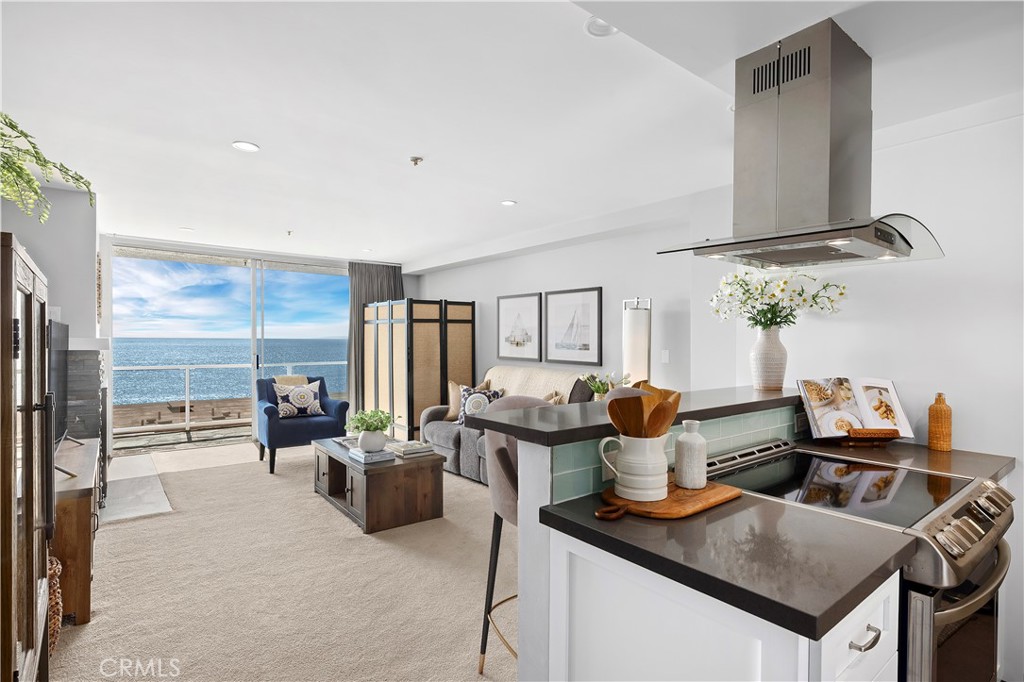 a kitchen with stainless steel appliances kitchen island granite countertop a table and chairs