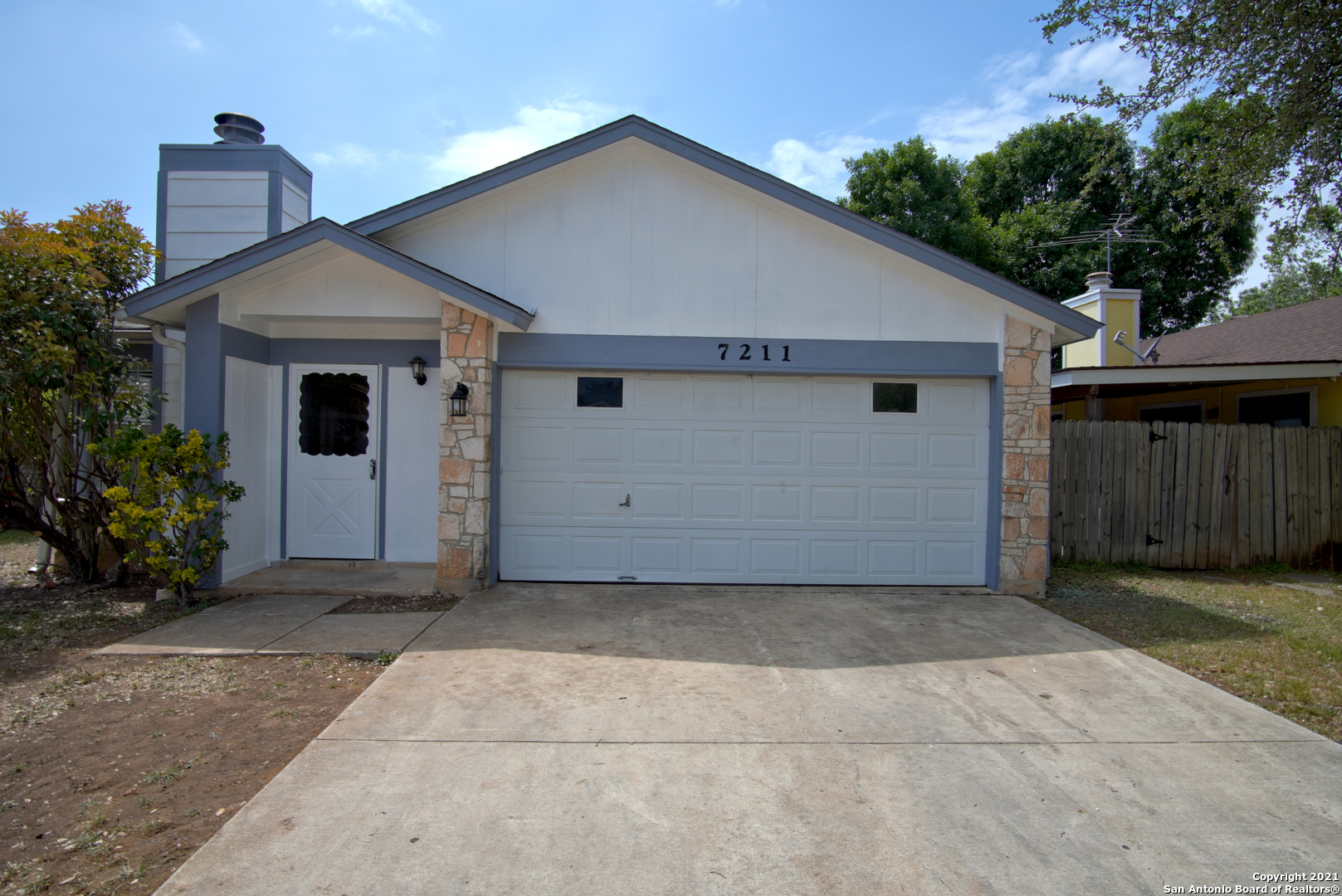 a view of a house with a yard and garage