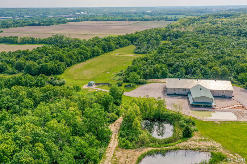 an aerial view of a house with garden space and outdoor seating