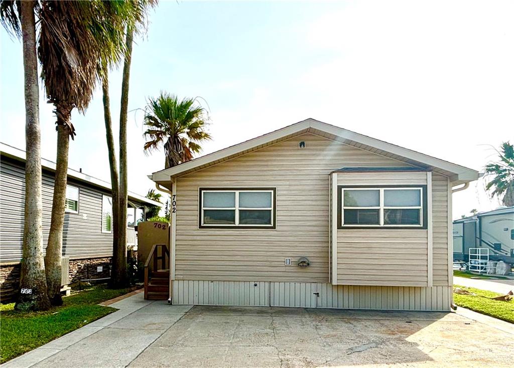 a view of a house with a backyard