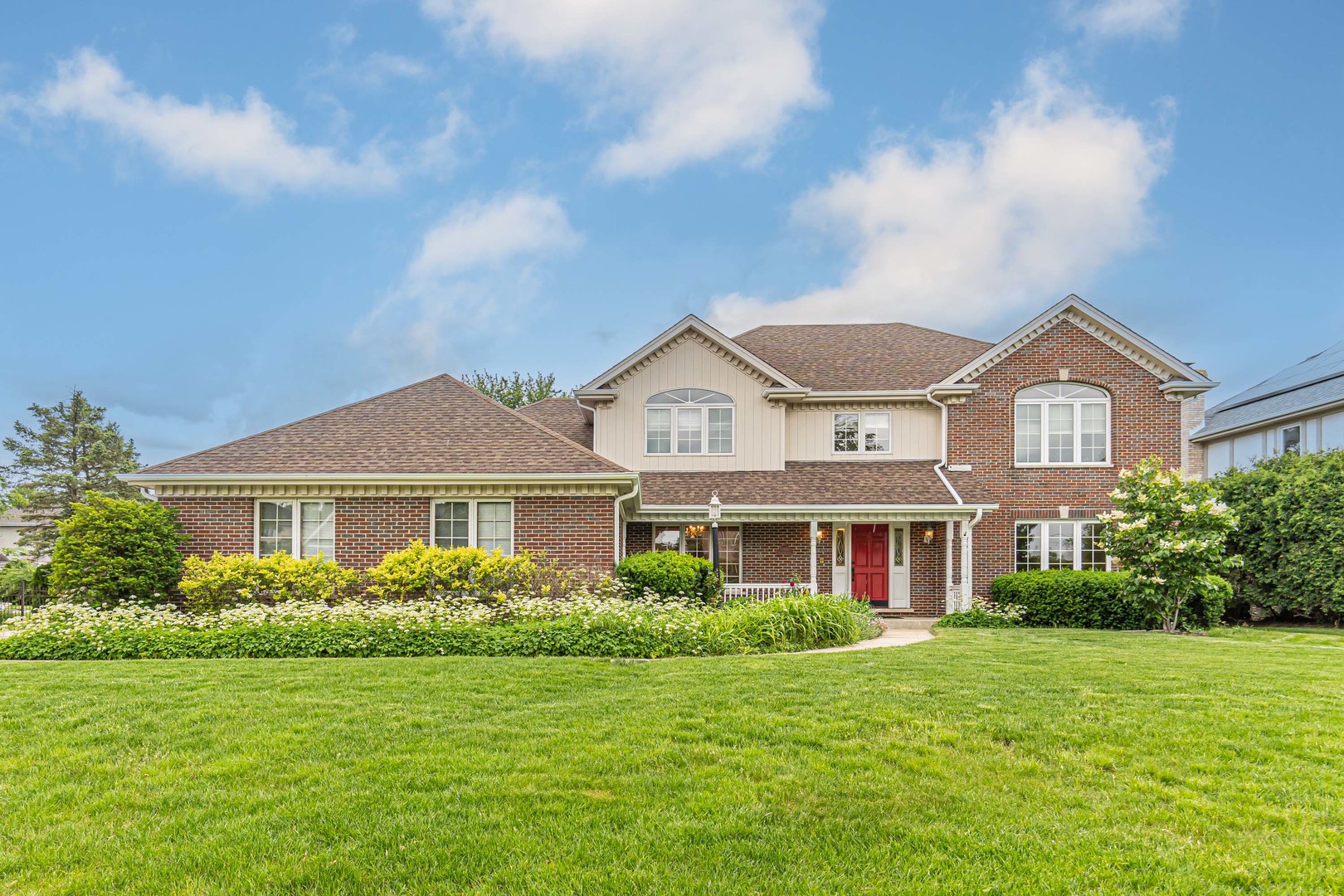 a front view of a house with a garden