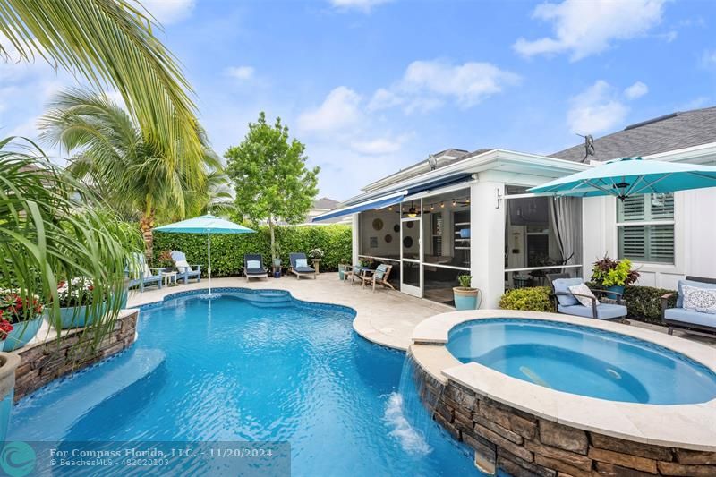 a view of a house with swimming pool and sitting area