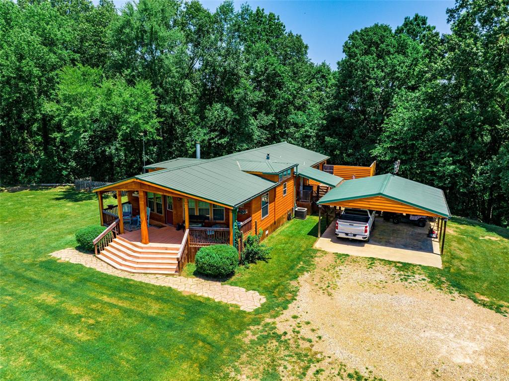 an aerial view of a house with swimming pool and big yard