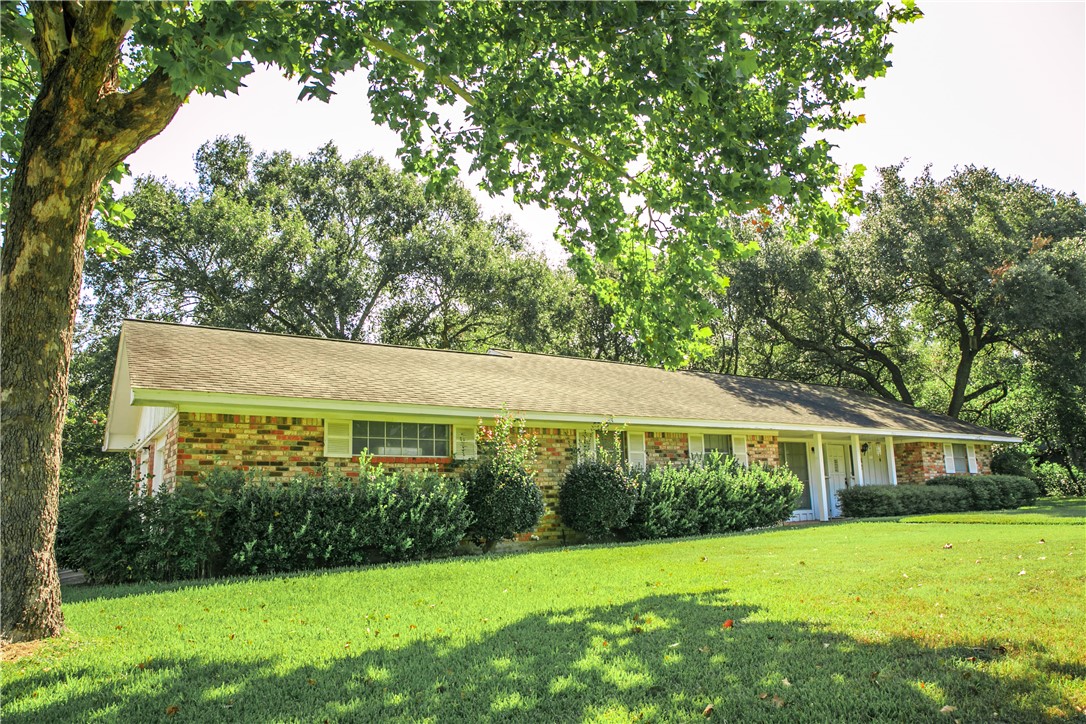 Ranch-style home featuring a front yard