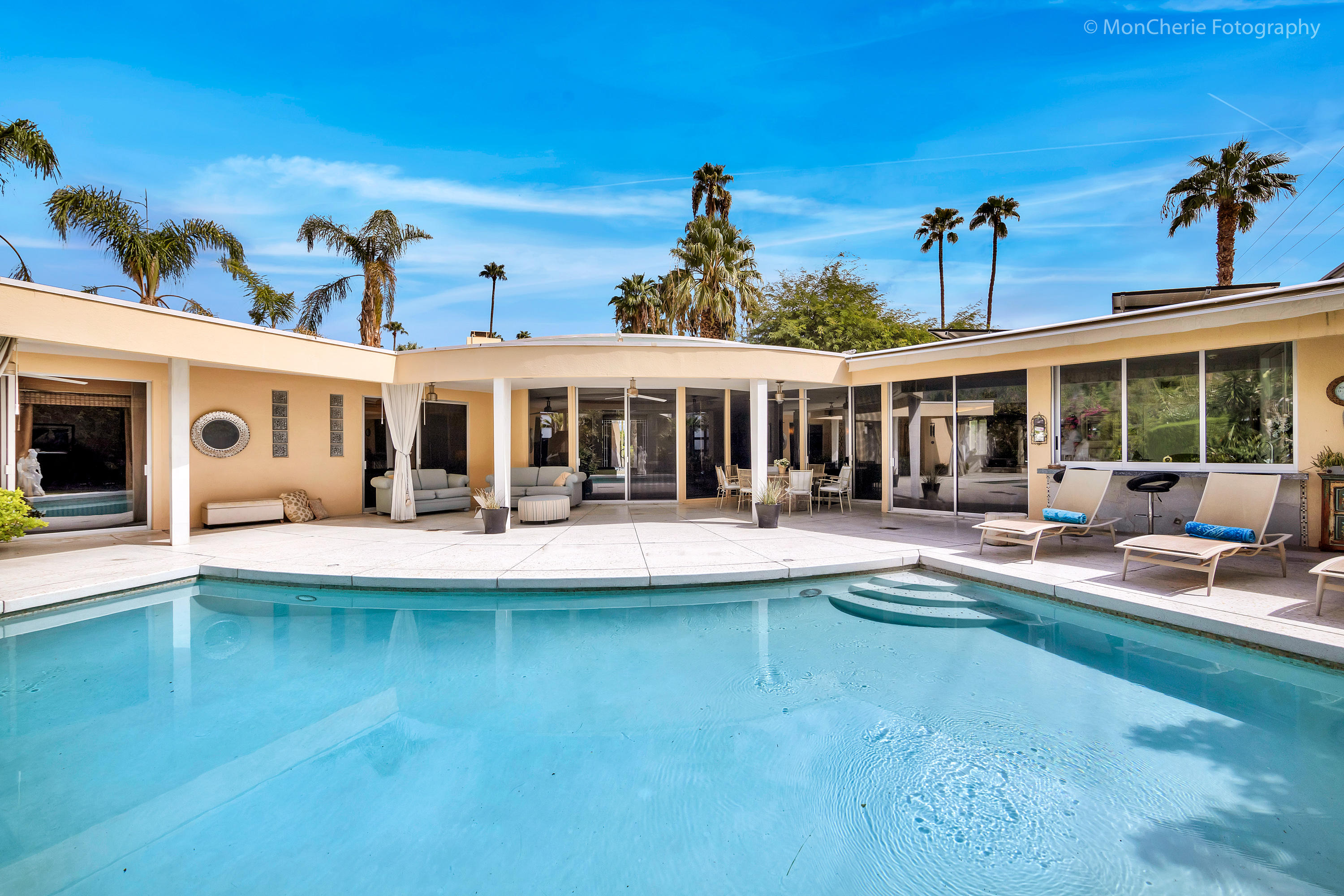 a view of a house with swimming pool and porch