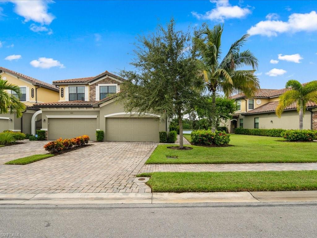 a front view of a house with a yard and garage