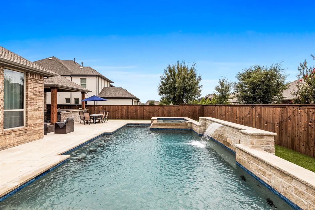 a view of a house with pool and sitting area