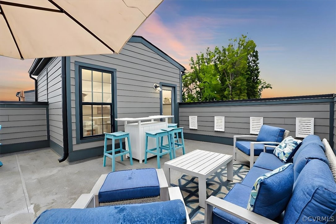 a view of a patio with table and chairs with a barbeque grill and plants