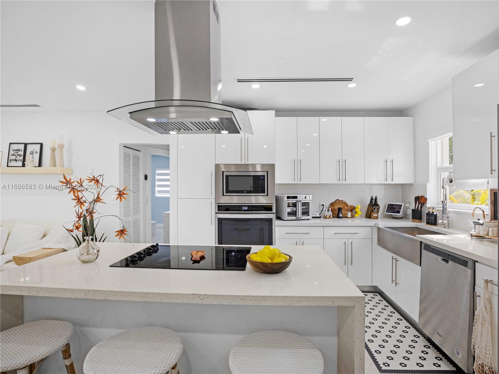 a kitchen with a sink a stove and cabinets