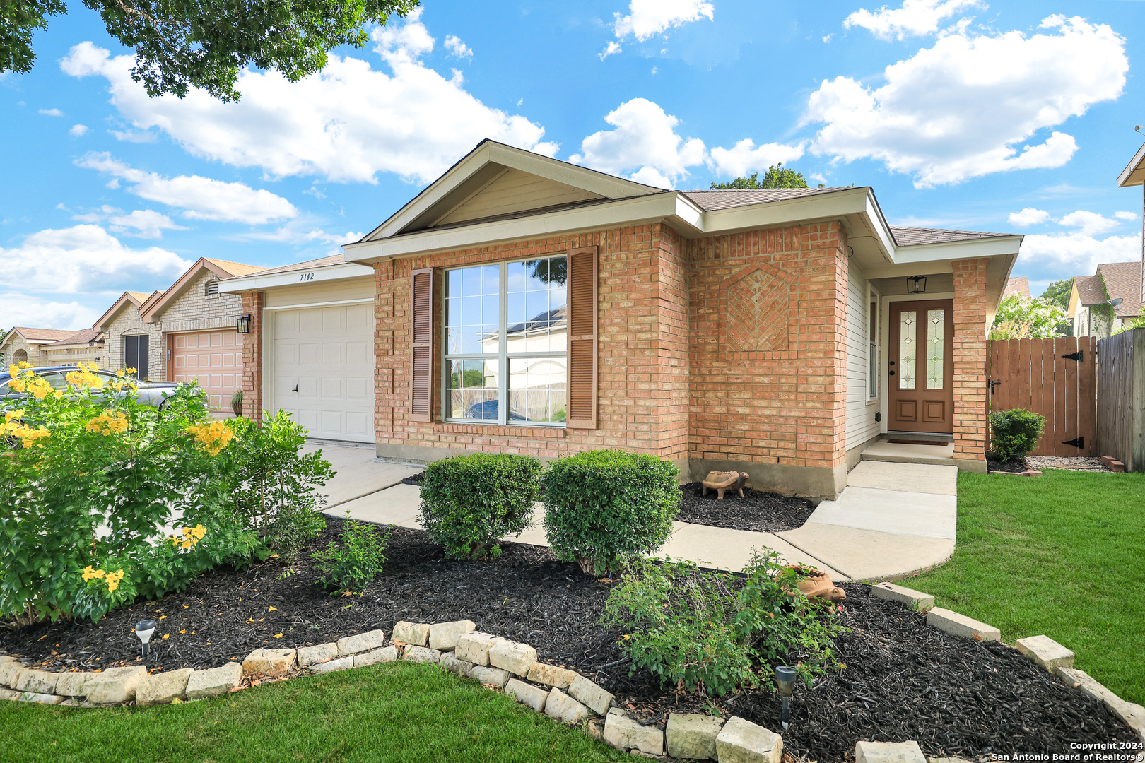 a front view of a house with garden