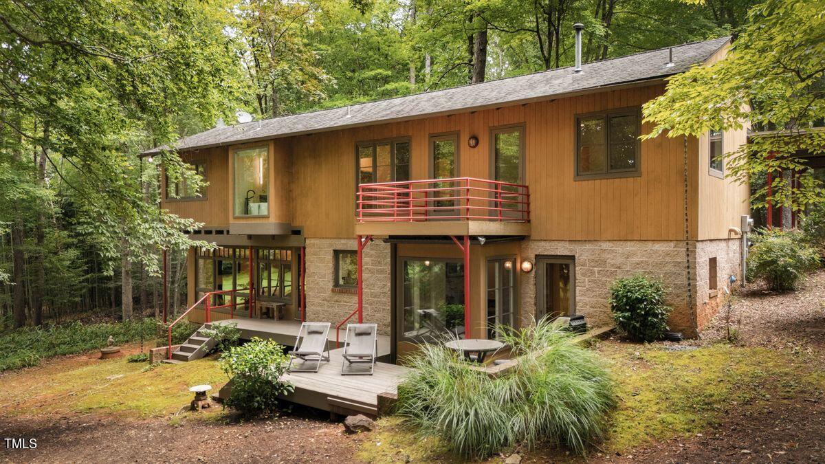 a view of a house with backyard and sitting area