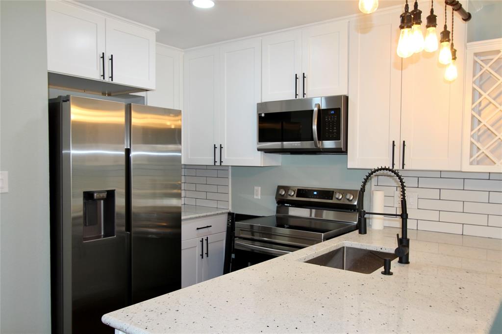 a kitchen with a refrigerator sink and stove