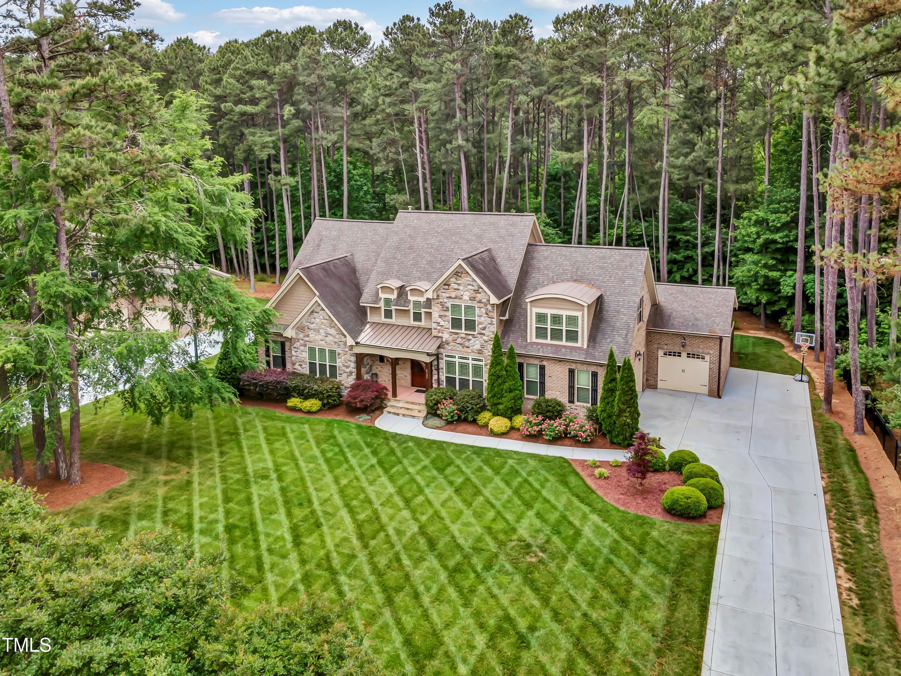 a aerial view of a house with swimming pool and garden