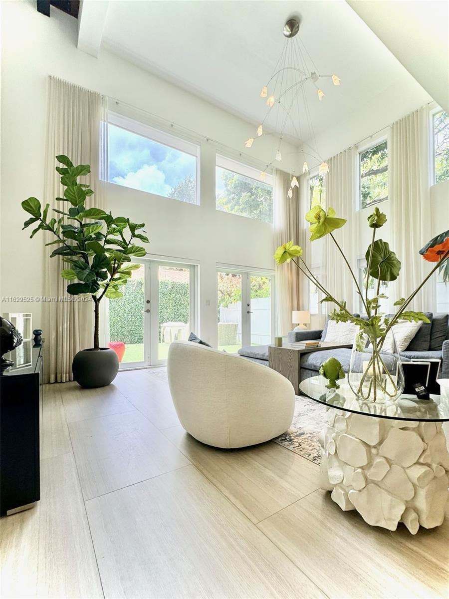 a living room filled with furniture and a potted plant