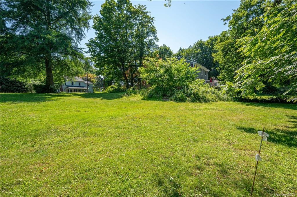 a view of yard with swimming pool and green space