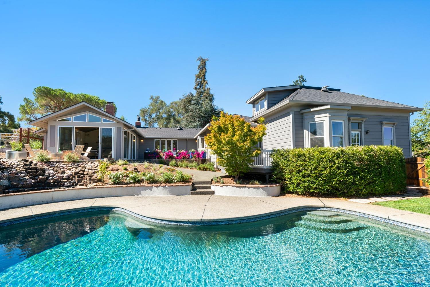 Welcome to 112 Ravenswood! This solar-heated pool is located in the rear of the main home and features expansive views, privacy, and an adjacent waterfall.