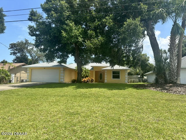 a house that is sitting in a yard with large trees