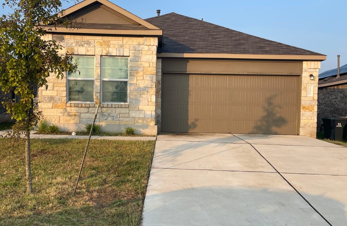 a front view of a house with a garage