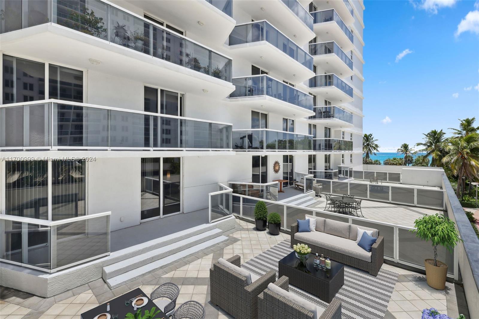 a balcony with table and chairs