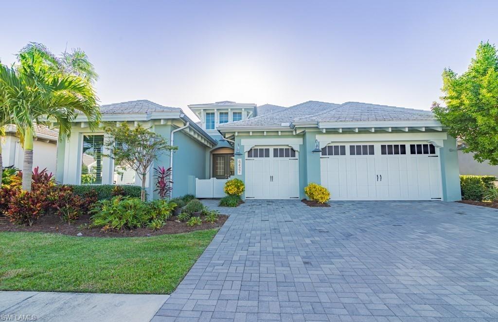 a view of a house with backyard and sitting area