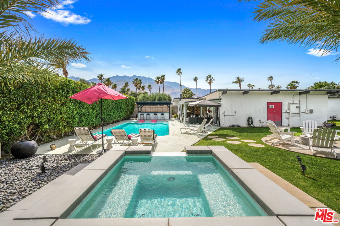 a view of an house with backyard space and patio