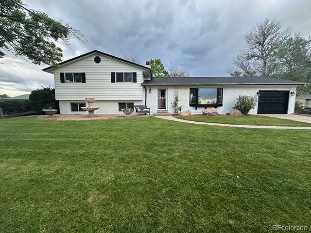 a view of a house with a yard and sitting area