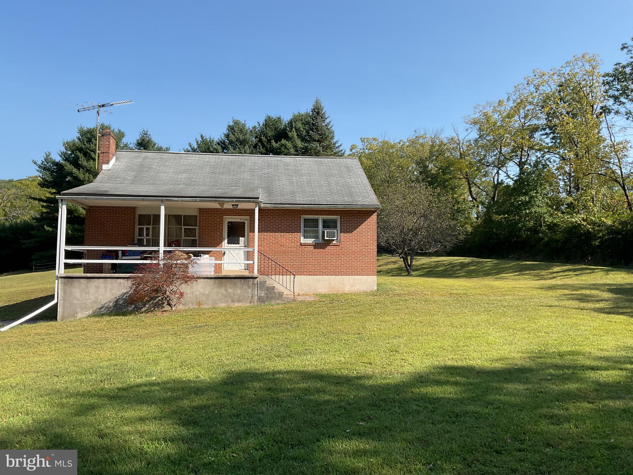 a view of a house with swimming pool next to a yard