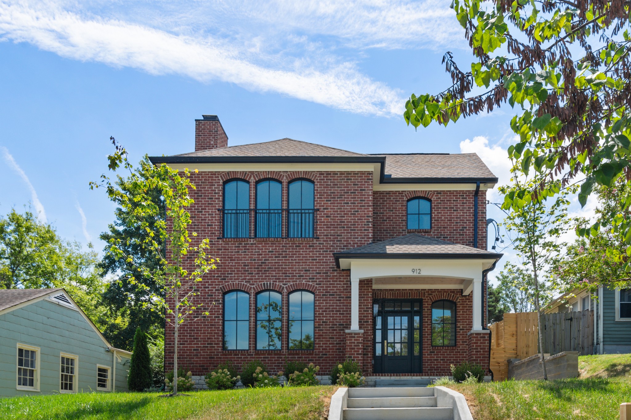 a front view of a house with a garden