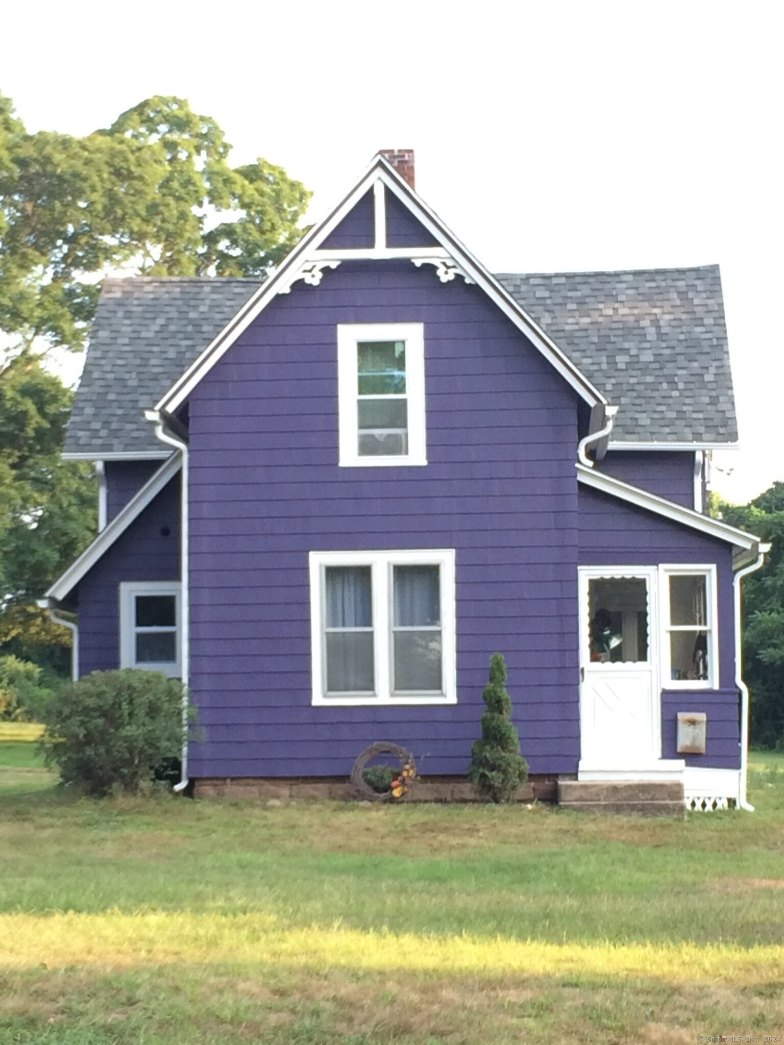 a front view of a house with a garden