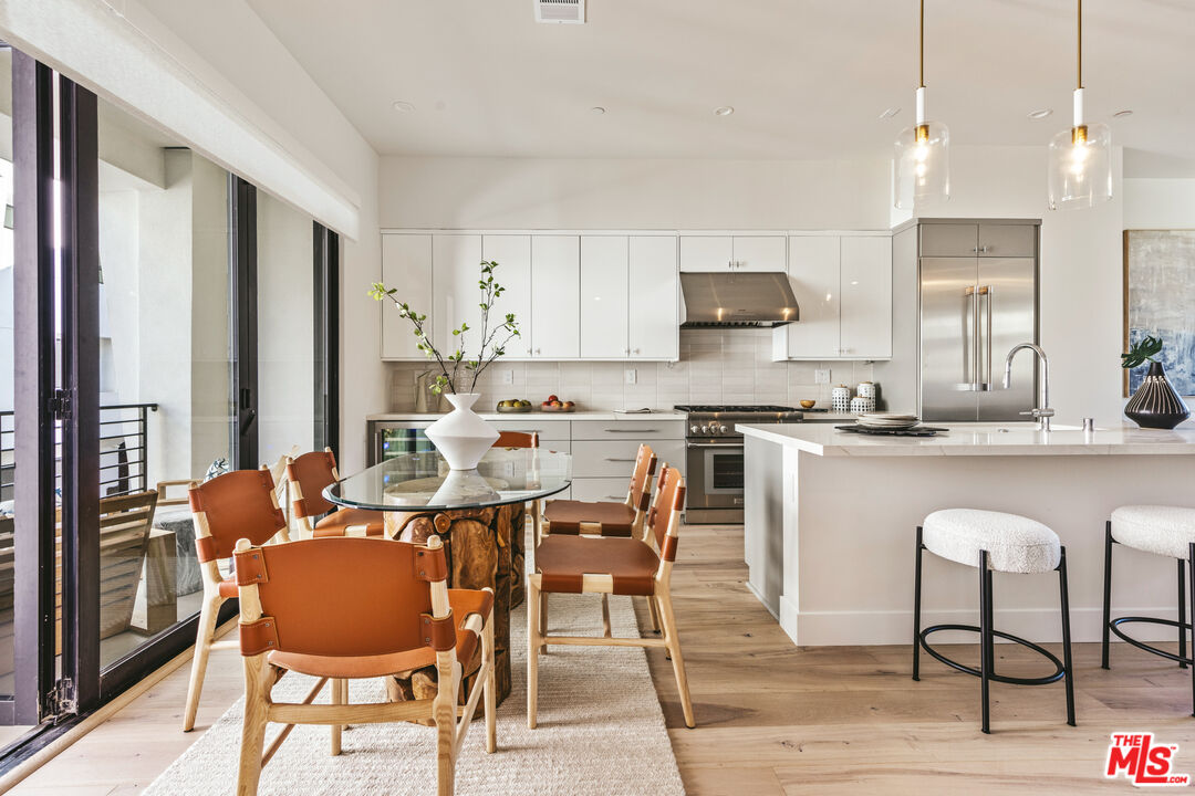 a living room with stainless steel appliances kitchen island granite countertop furniture and a kitchen view