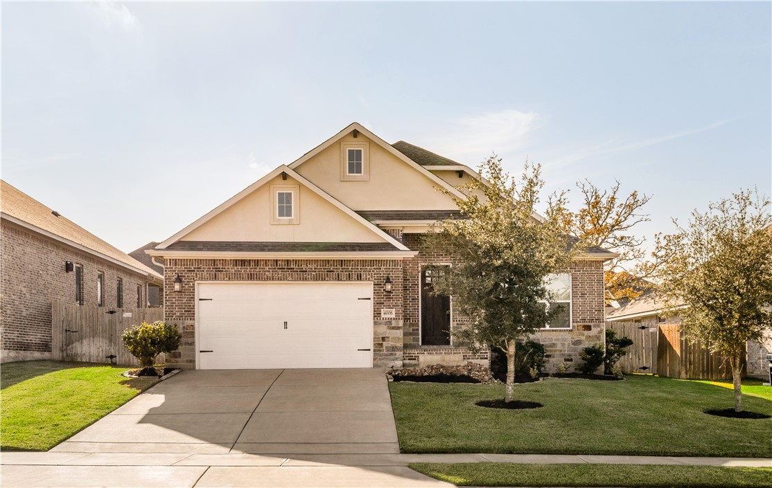 Exterior Front with a two-car garage and a front y