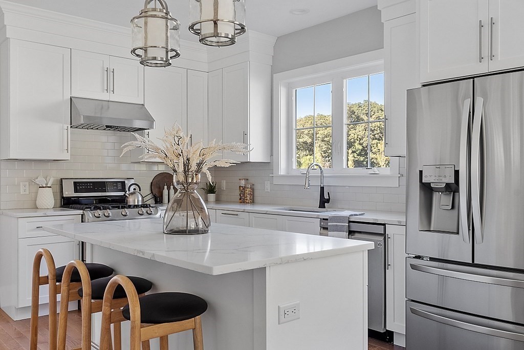 a kitchen with appliances cabinets and a counter top space