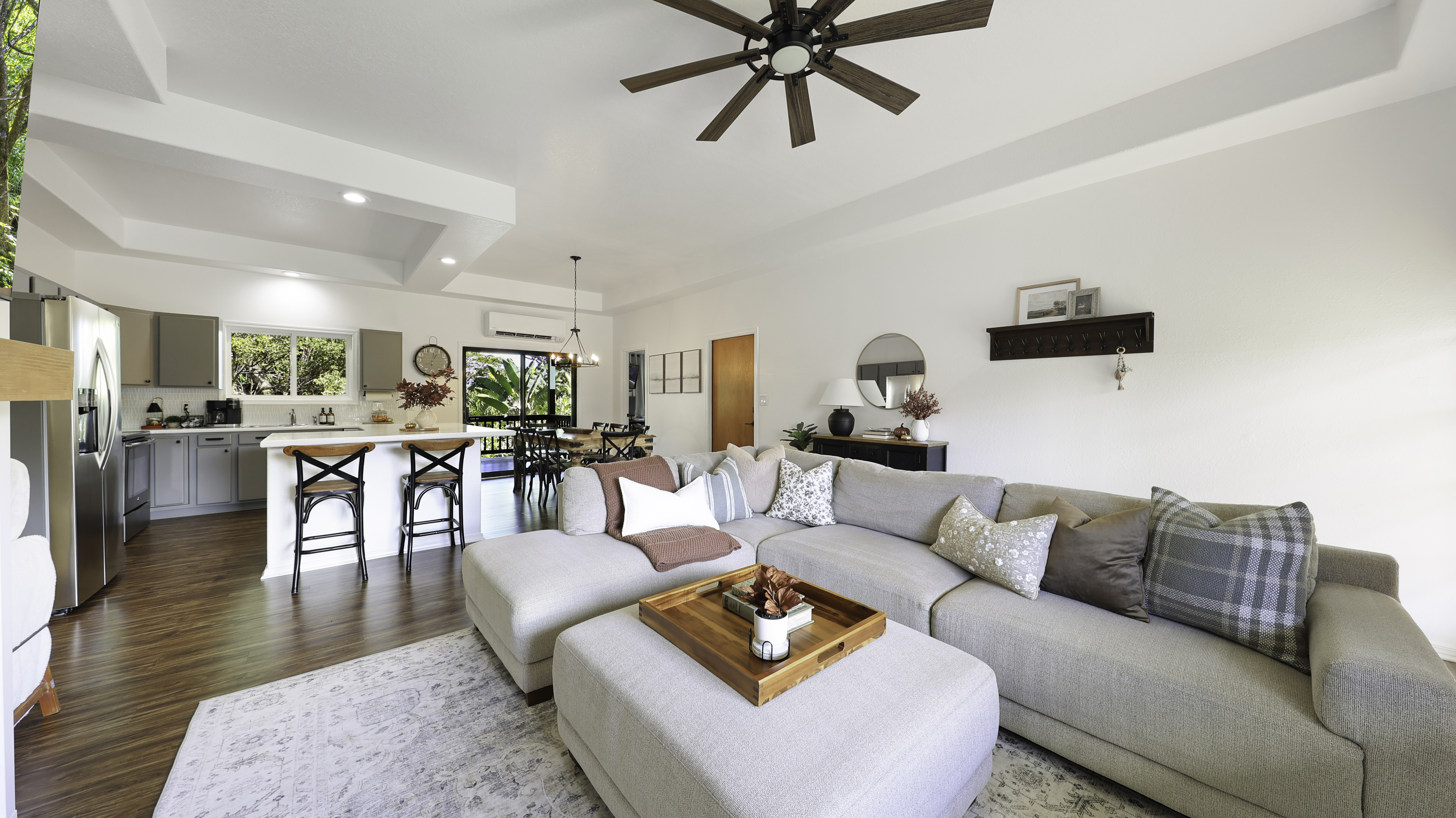 a living room with furniture and a wooden floor