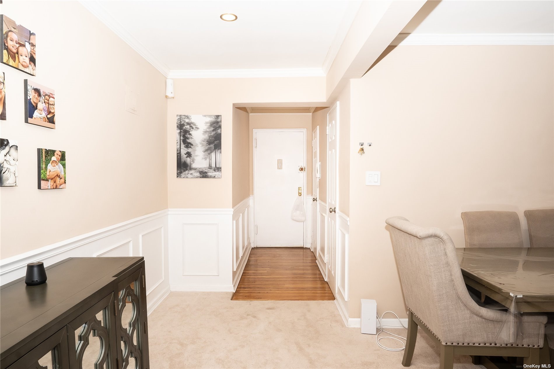 a hallway with furniture and wooden floor