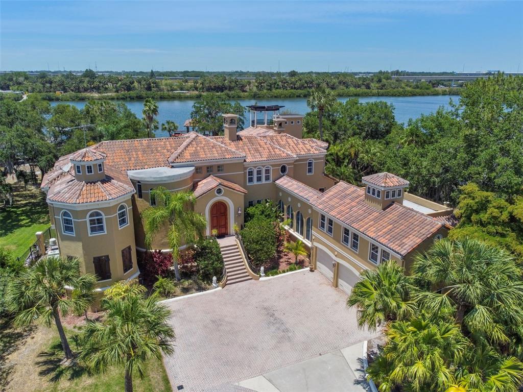 an aerial view of a house with a garden and lake view