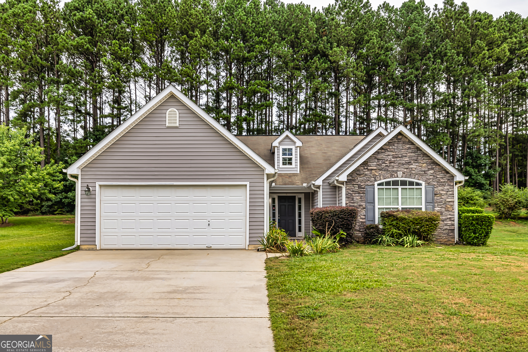 a front view of house with yard and green space