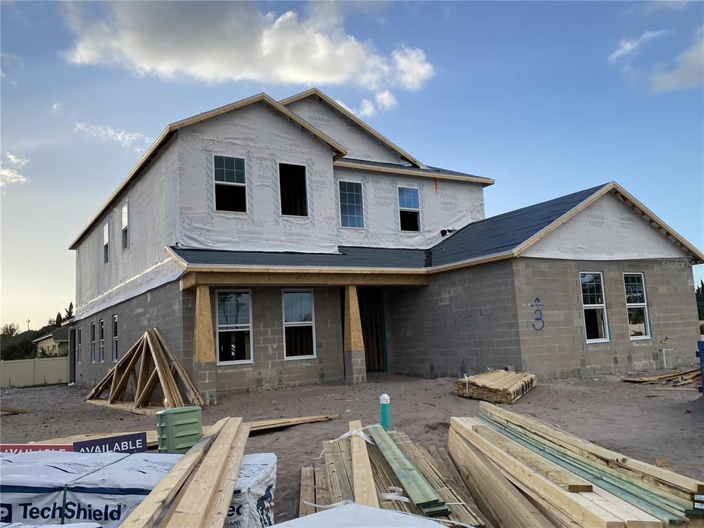 a view of house with backyard