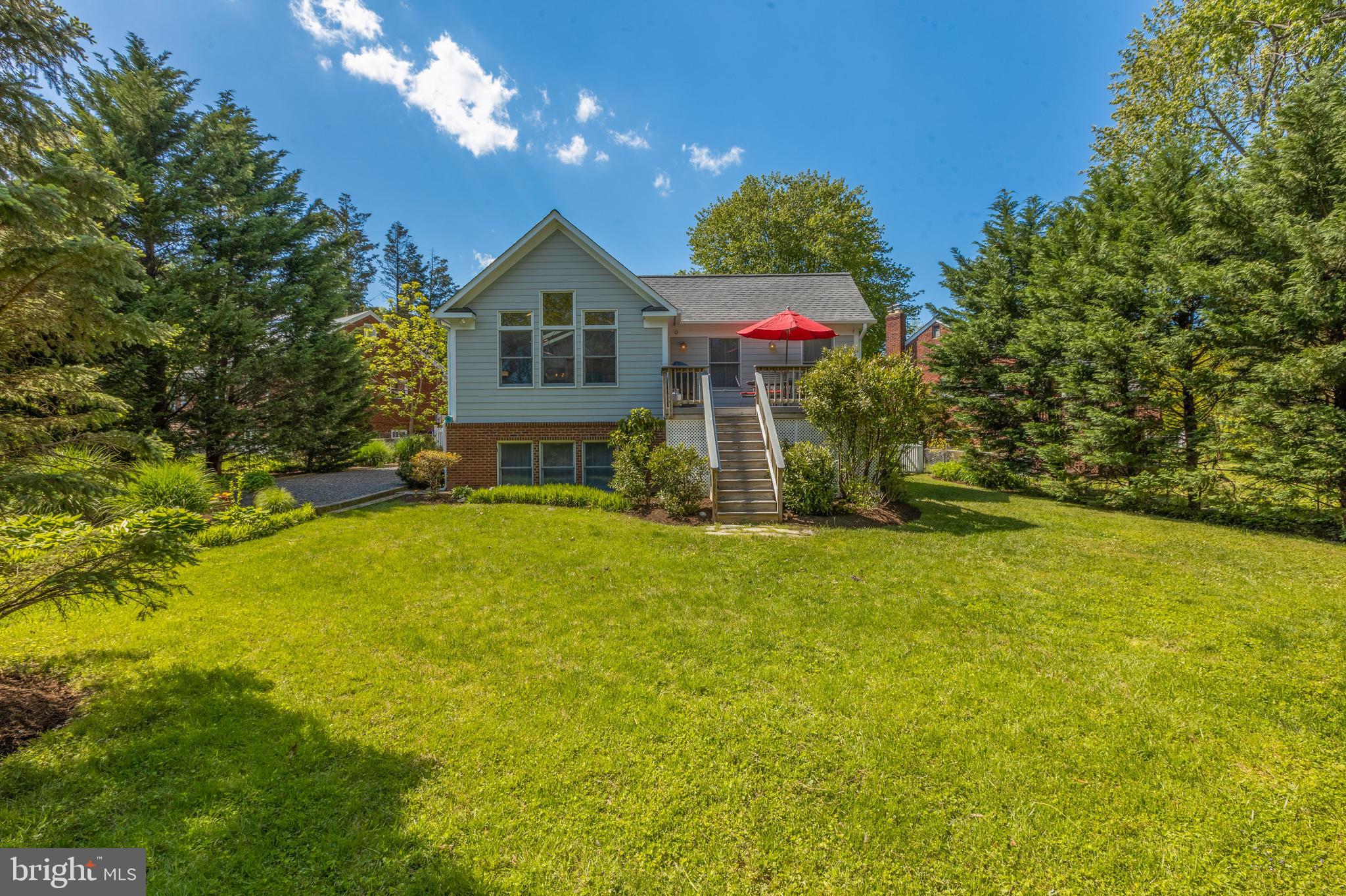 a front view of a house with yard and swimming pool