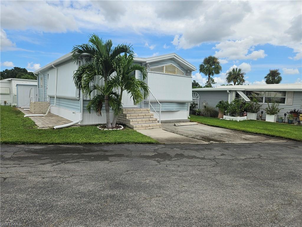 a front view of house with yard and green space