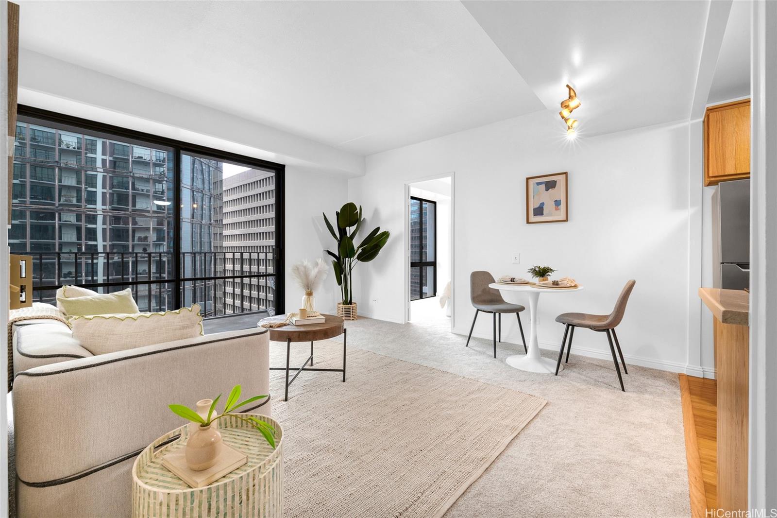 a living room with furniture and a floor to ceiling window