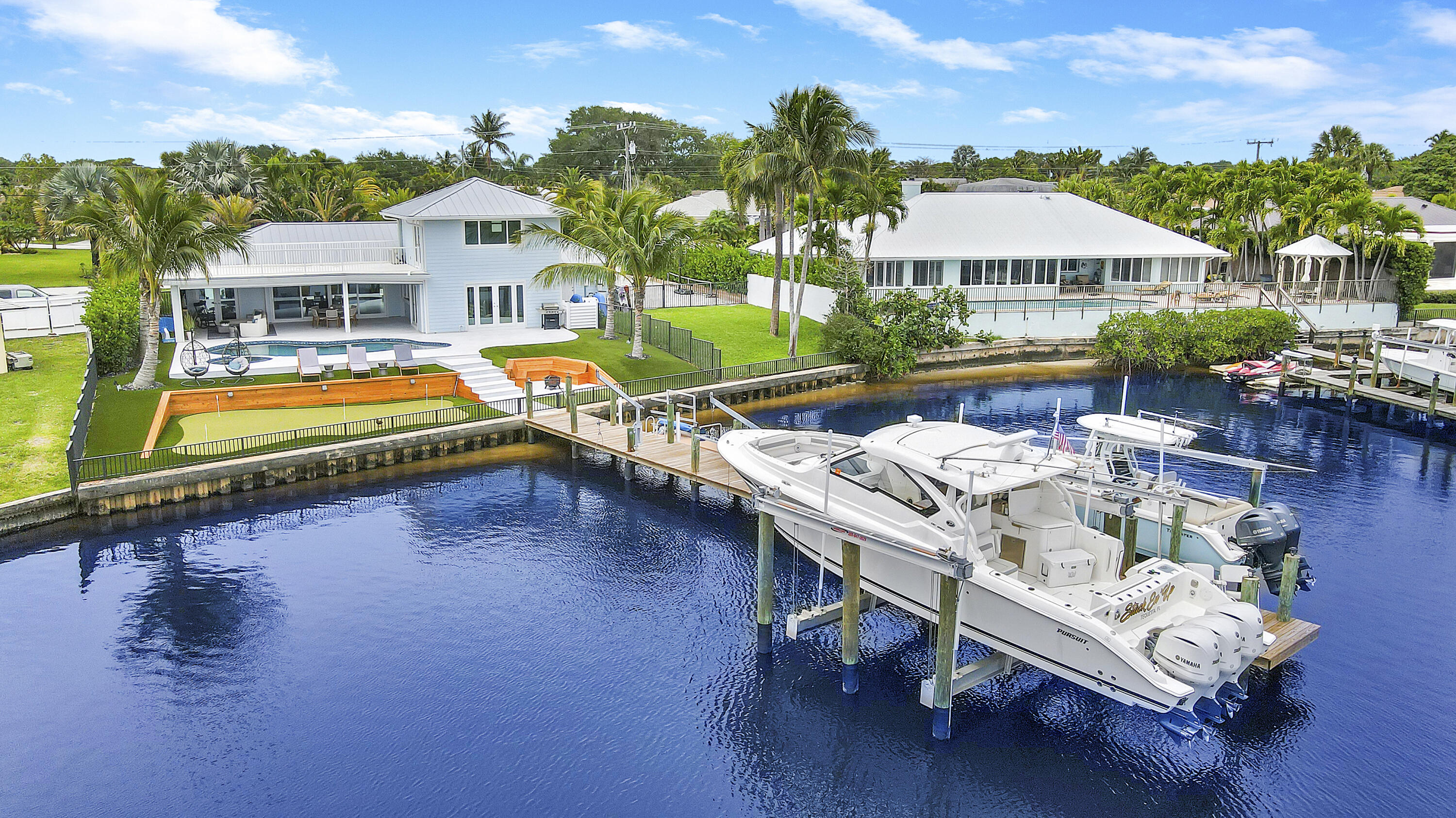 a swimming pool with outdoor seating and yard