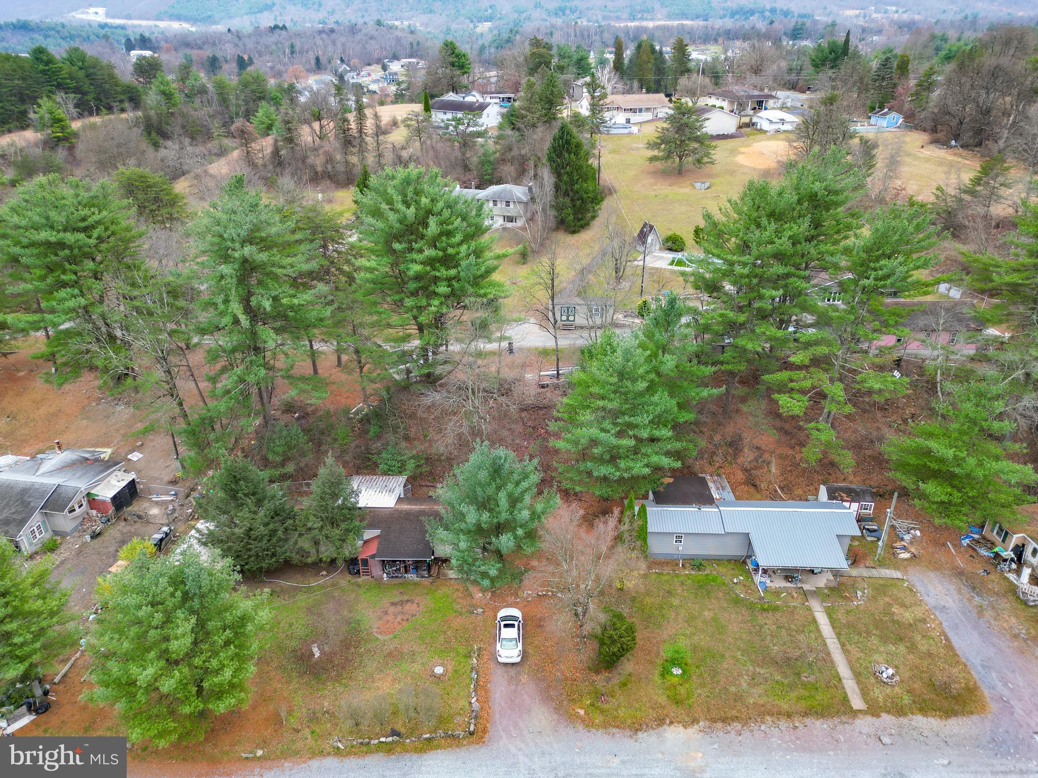 an aerial view of a house with a yard and lake view