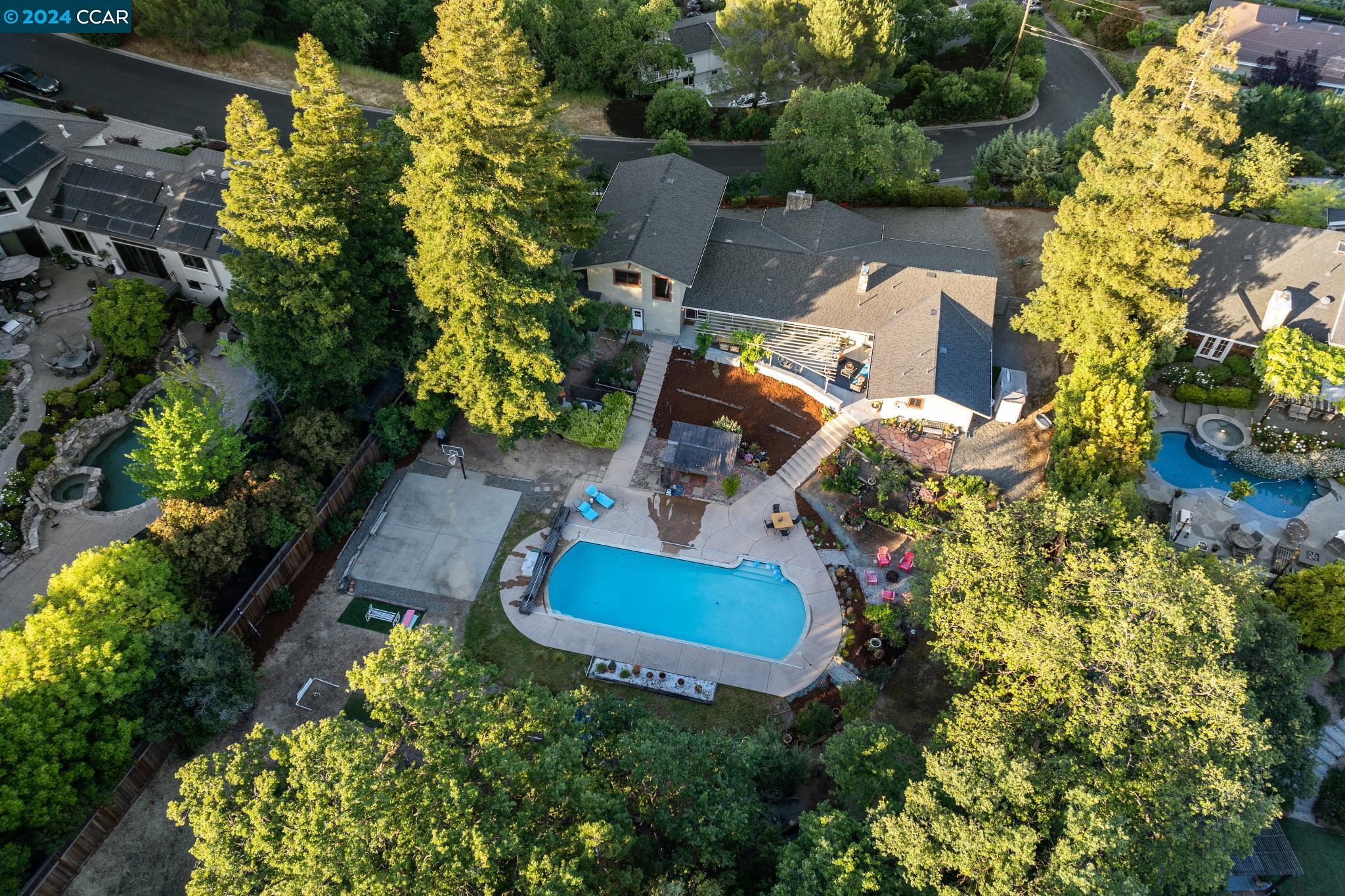 an aerial view of a house with a yard and garden