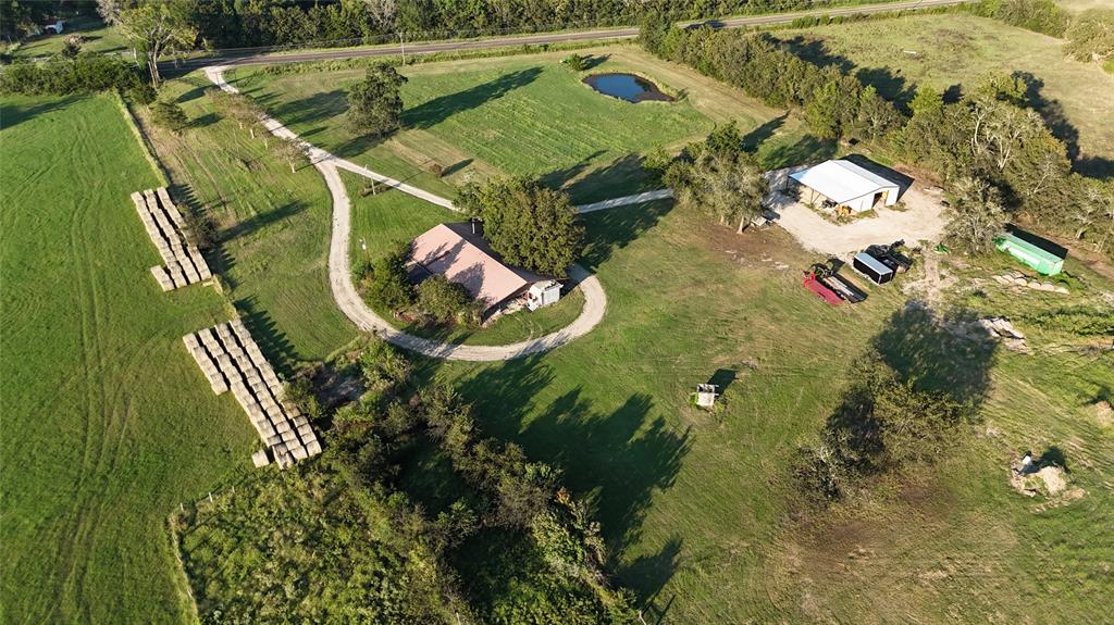 an aerial view of a house with outdoor space and a lake view