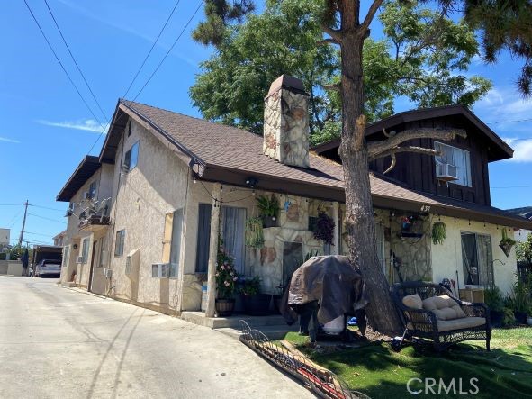 a view of a house with brick walls and a yard