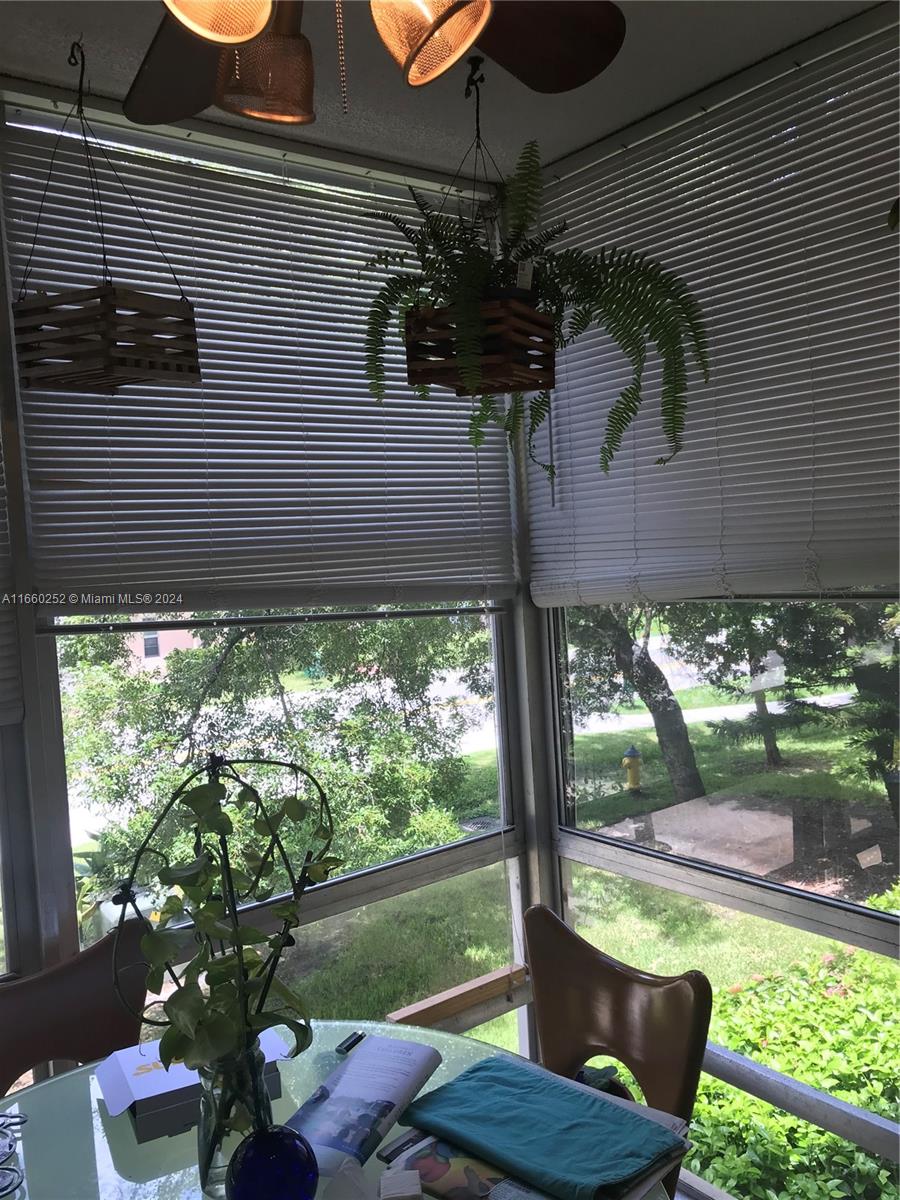 a lamp that is sitting in front of a house with a potted plant