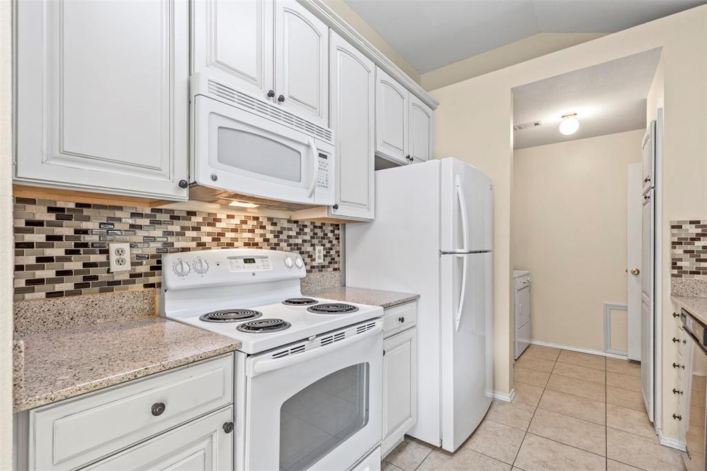 a kitchen with granite countertop cabinets and steel stainless steel appliances