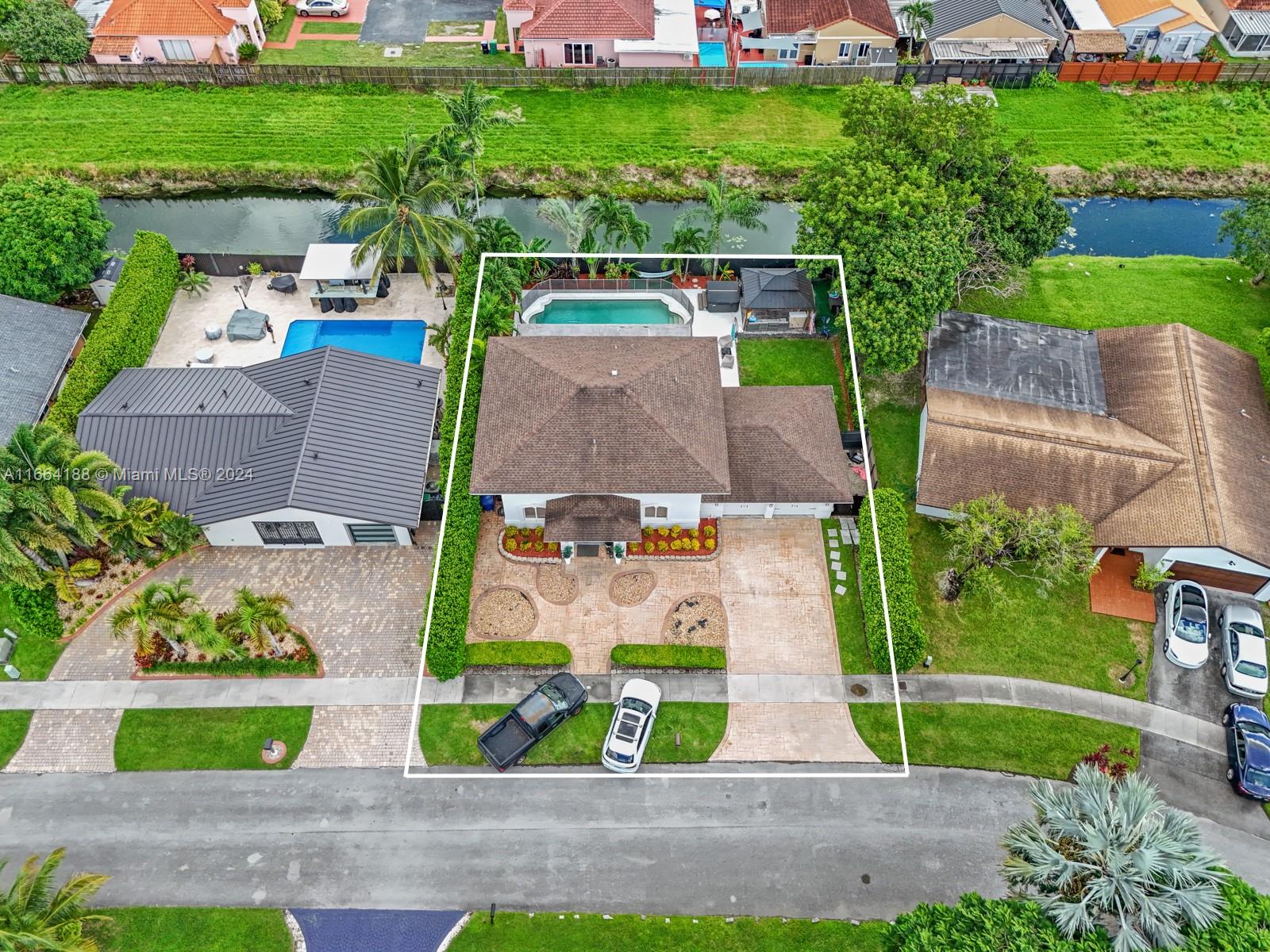 an aerial view of a house with garden space and street view